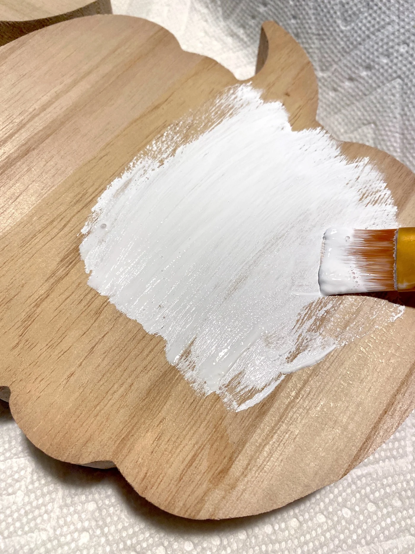 Pintando uma abóbora de madeira com tinta branca