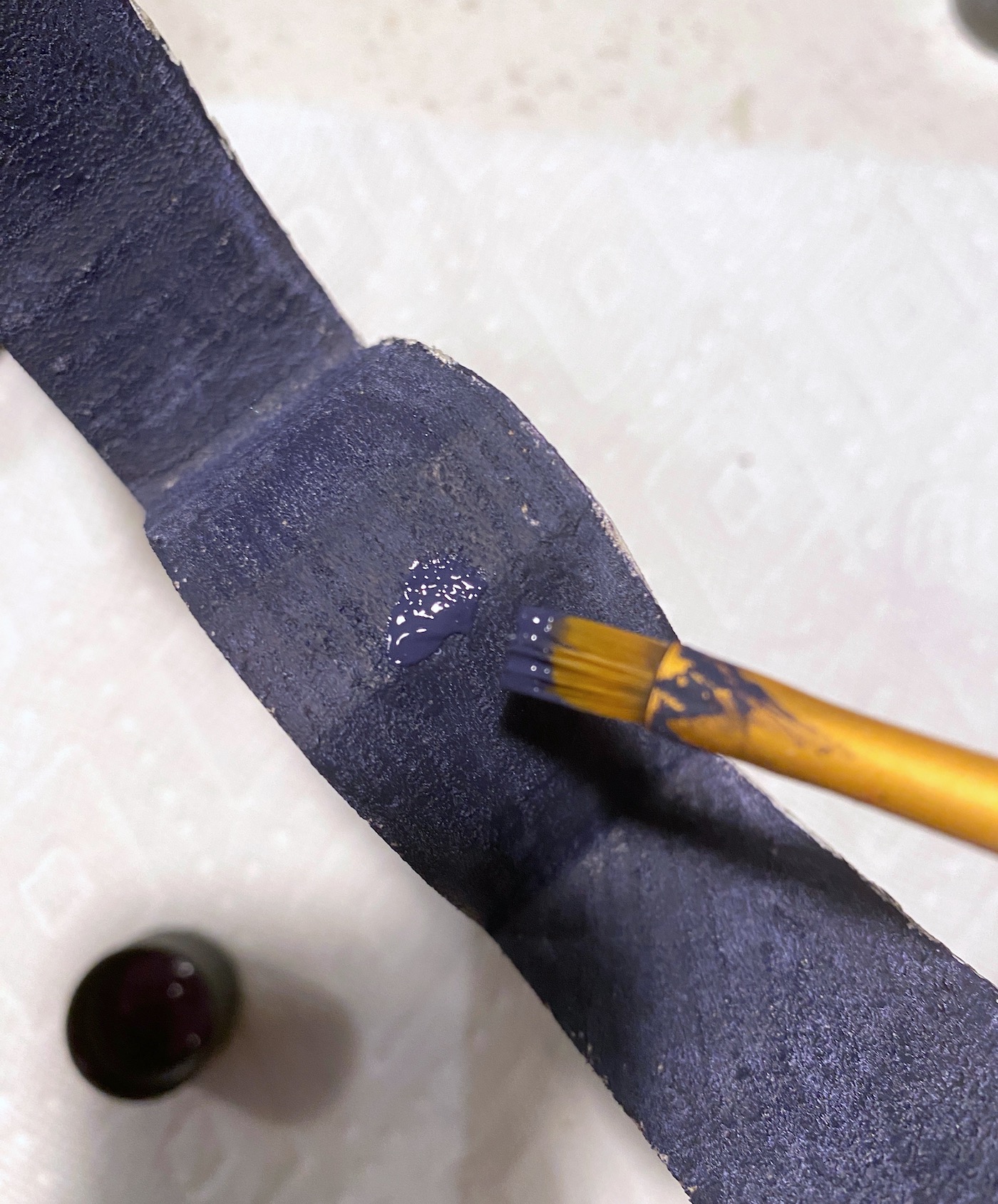 Painting the edges of the cutout with purple paint
