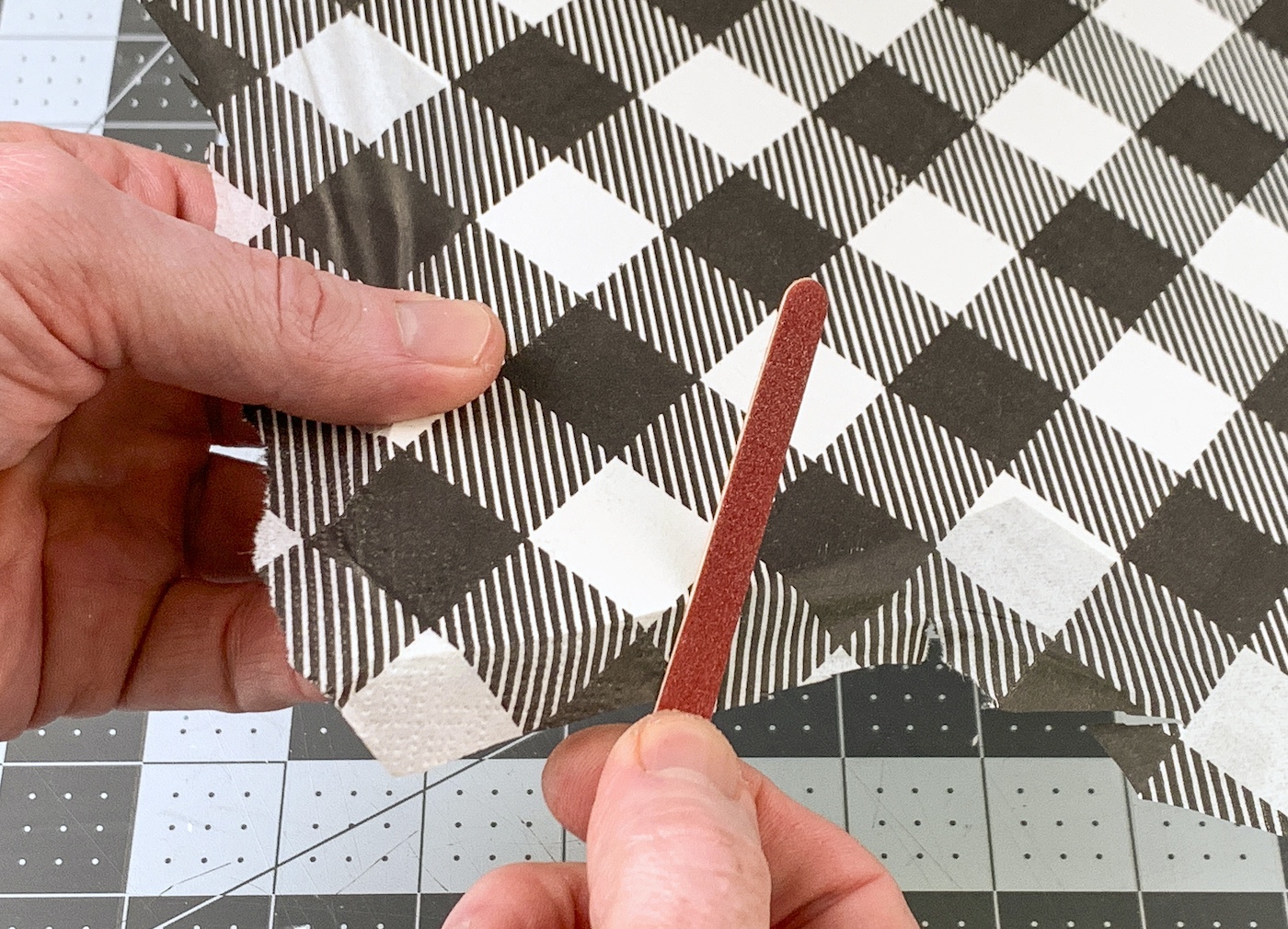 Sanding the edges of the napkins using an emery board