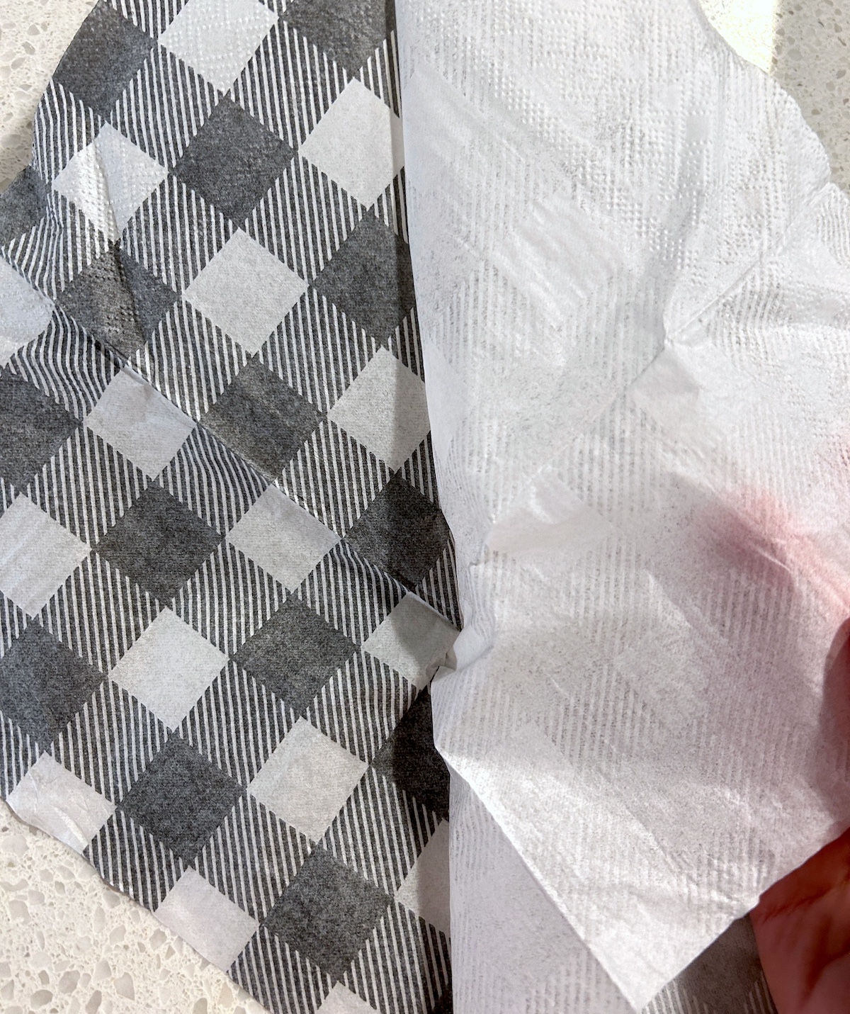 Separating layers of a buffalo plaid napkin