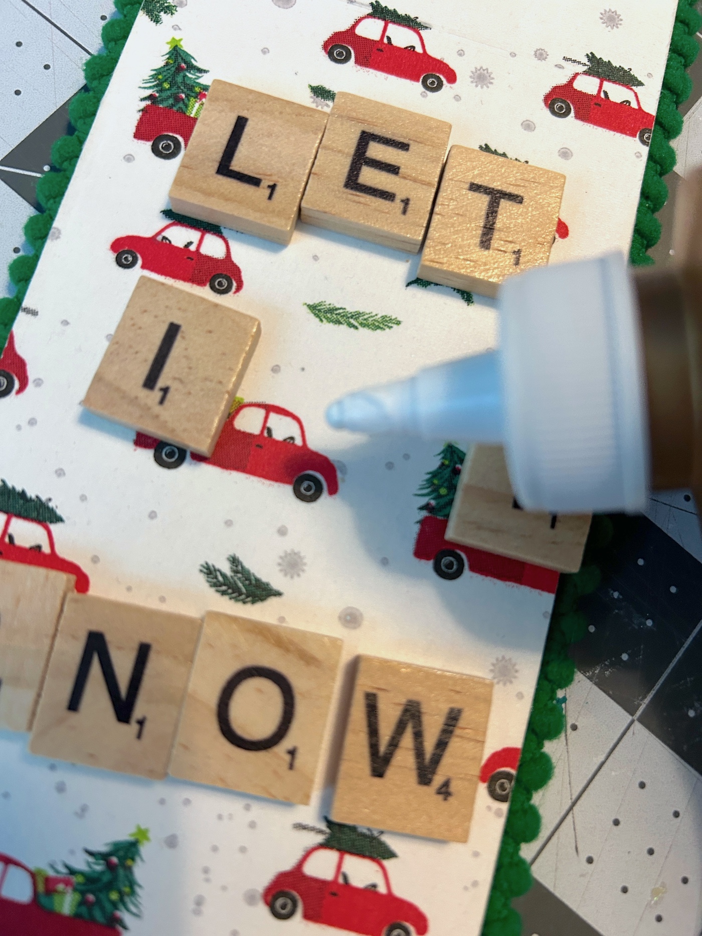 gluing scrabble tiles down on the front of a door hanger