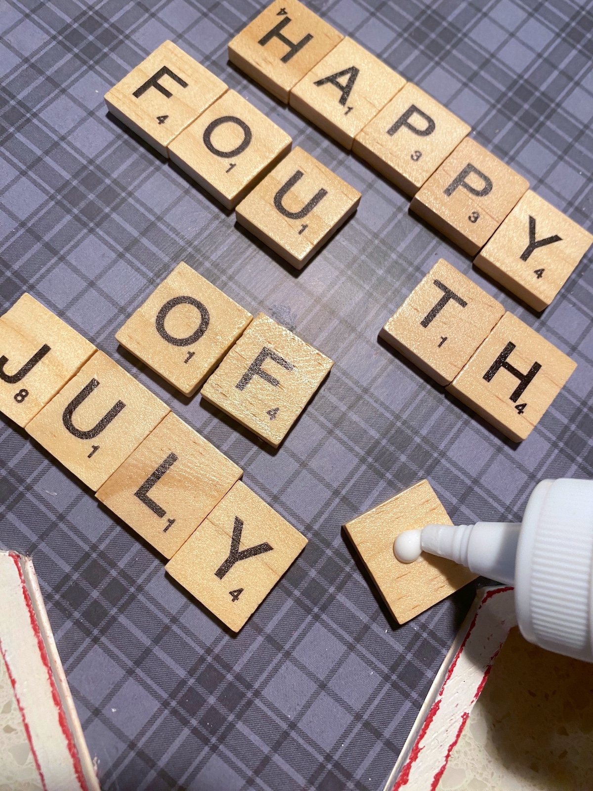 Gluing the scrabble tile letters onto the star