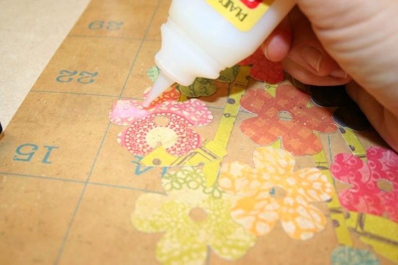 Applying Dimensional Magic to the flowers cut out of scrapbook paper