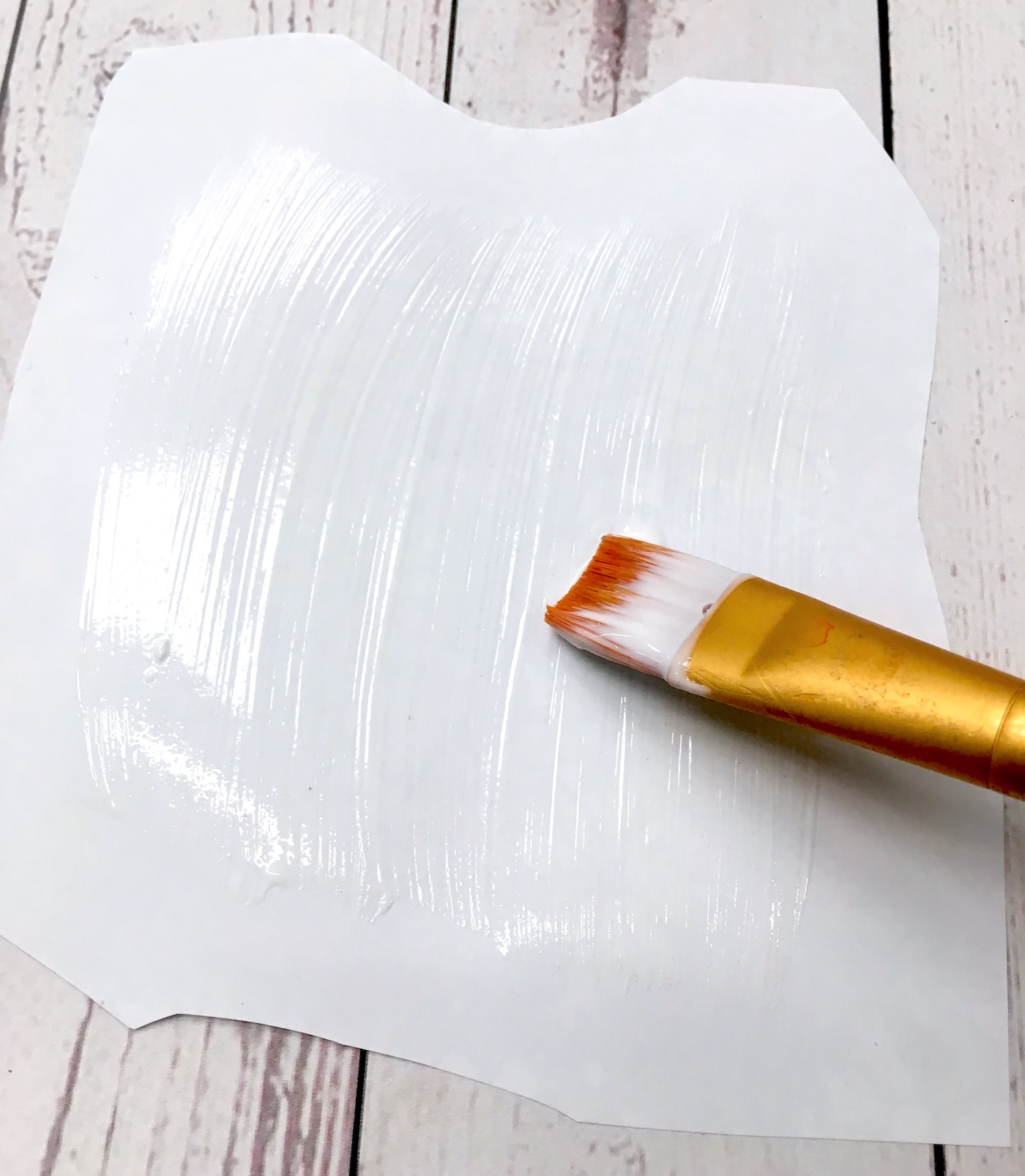 Applying Hard Coat to the back of a coloring page with a brush