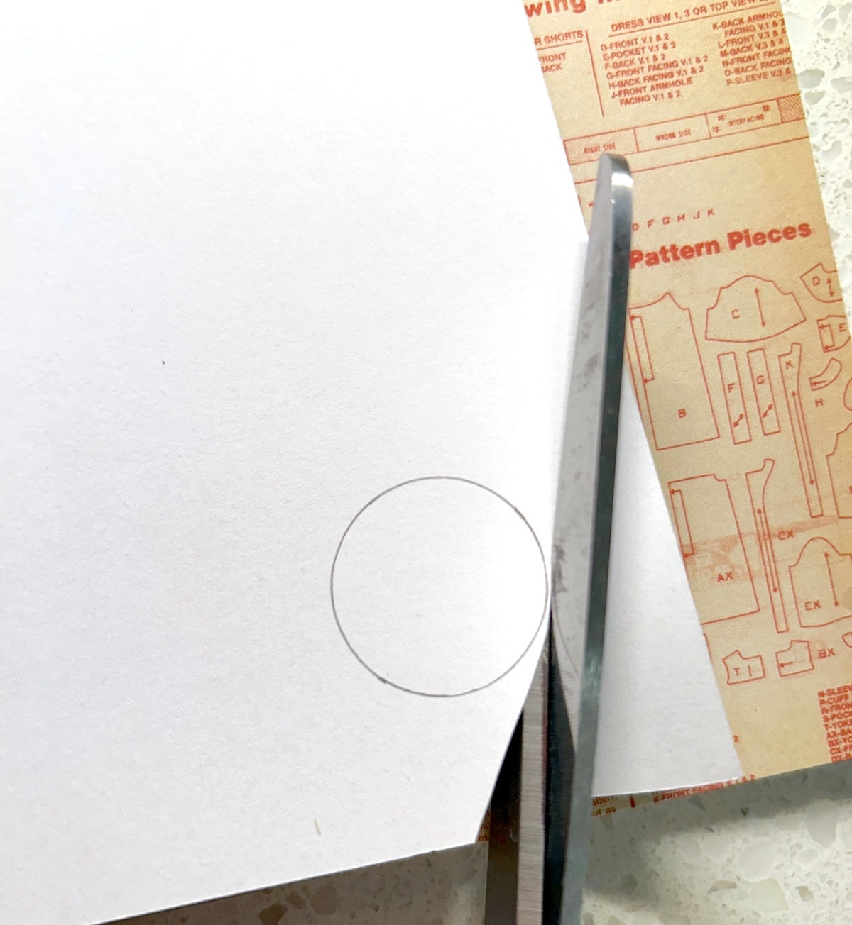 cutting out a circle traced on scrapbook paper