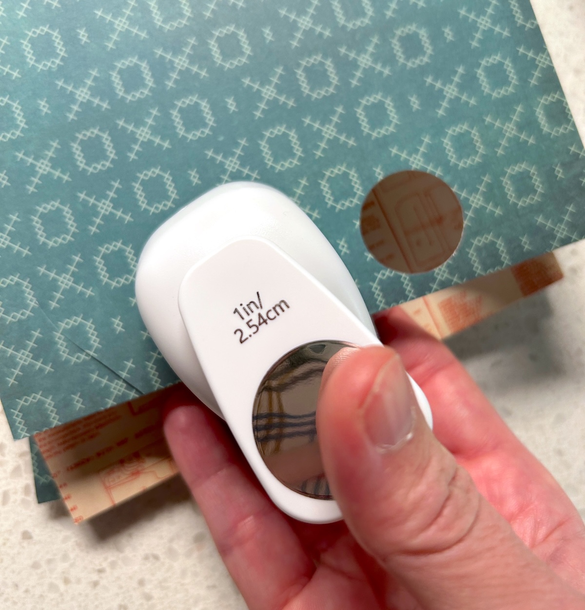 punching out paper with a one inch circle punch
