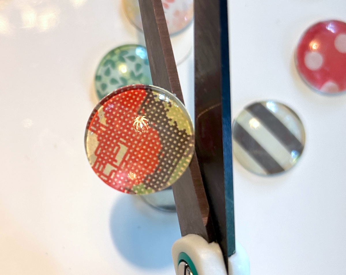 trimming around round glass marbles with scissors