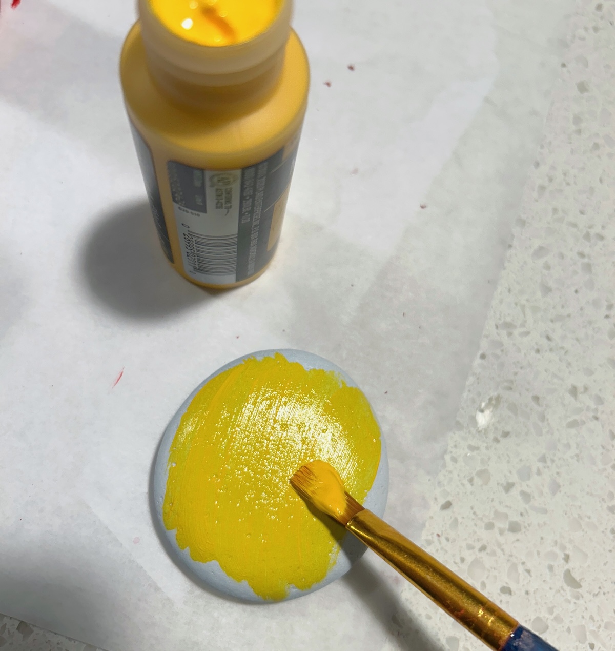 Painting one side of the rock with yellow