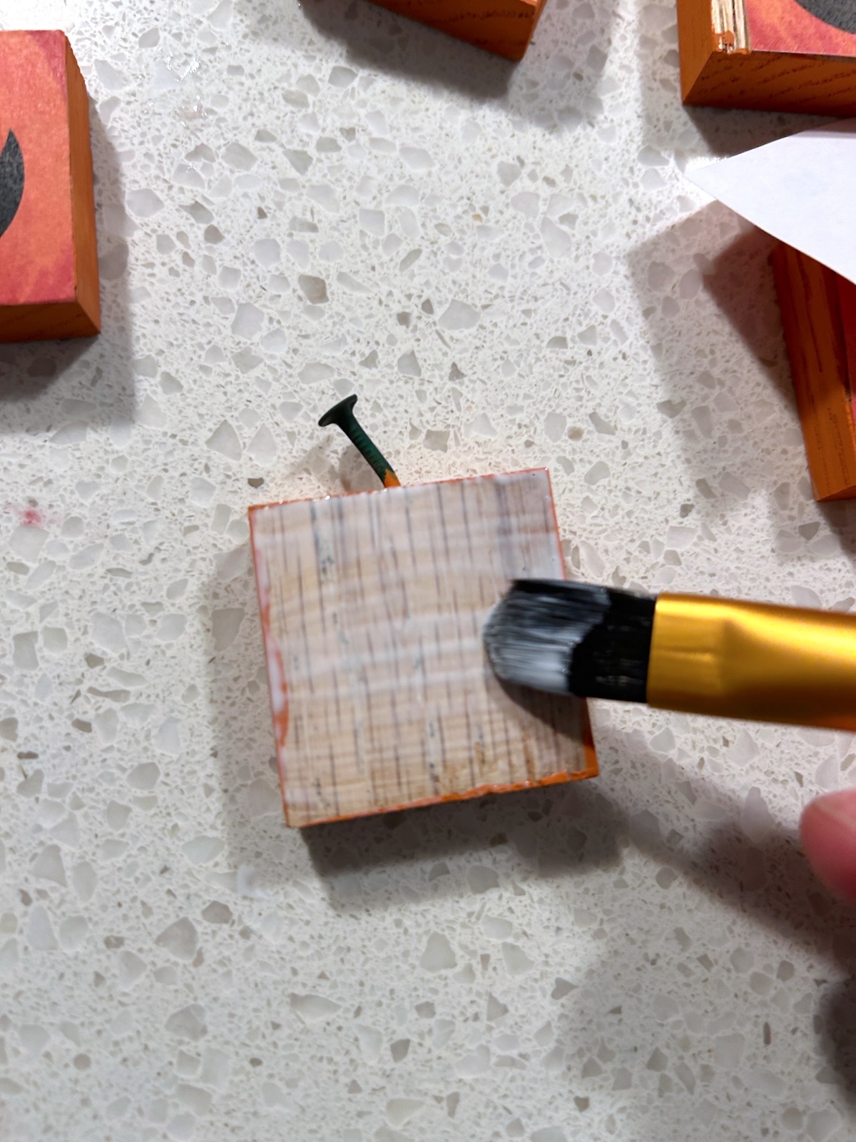 Applying Mod Podge to the wood block