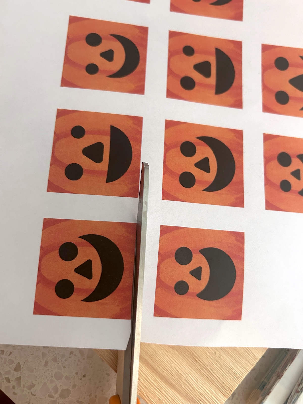 Cutting the pumpkin faces out of paper