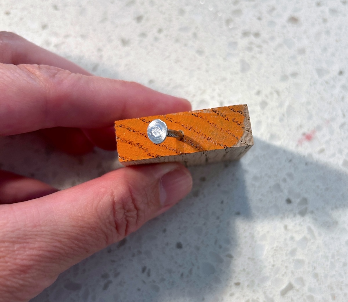 Painting the wood square with orange paint