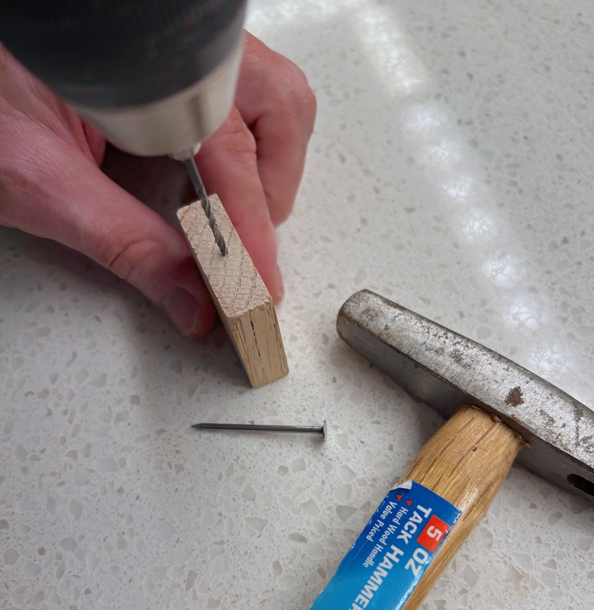Predrilling a hole into the wood block