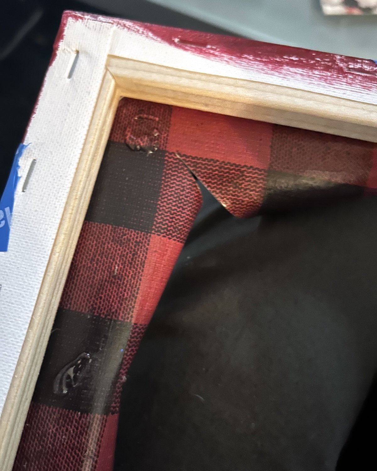 adding glue to the inside of the canvas edges