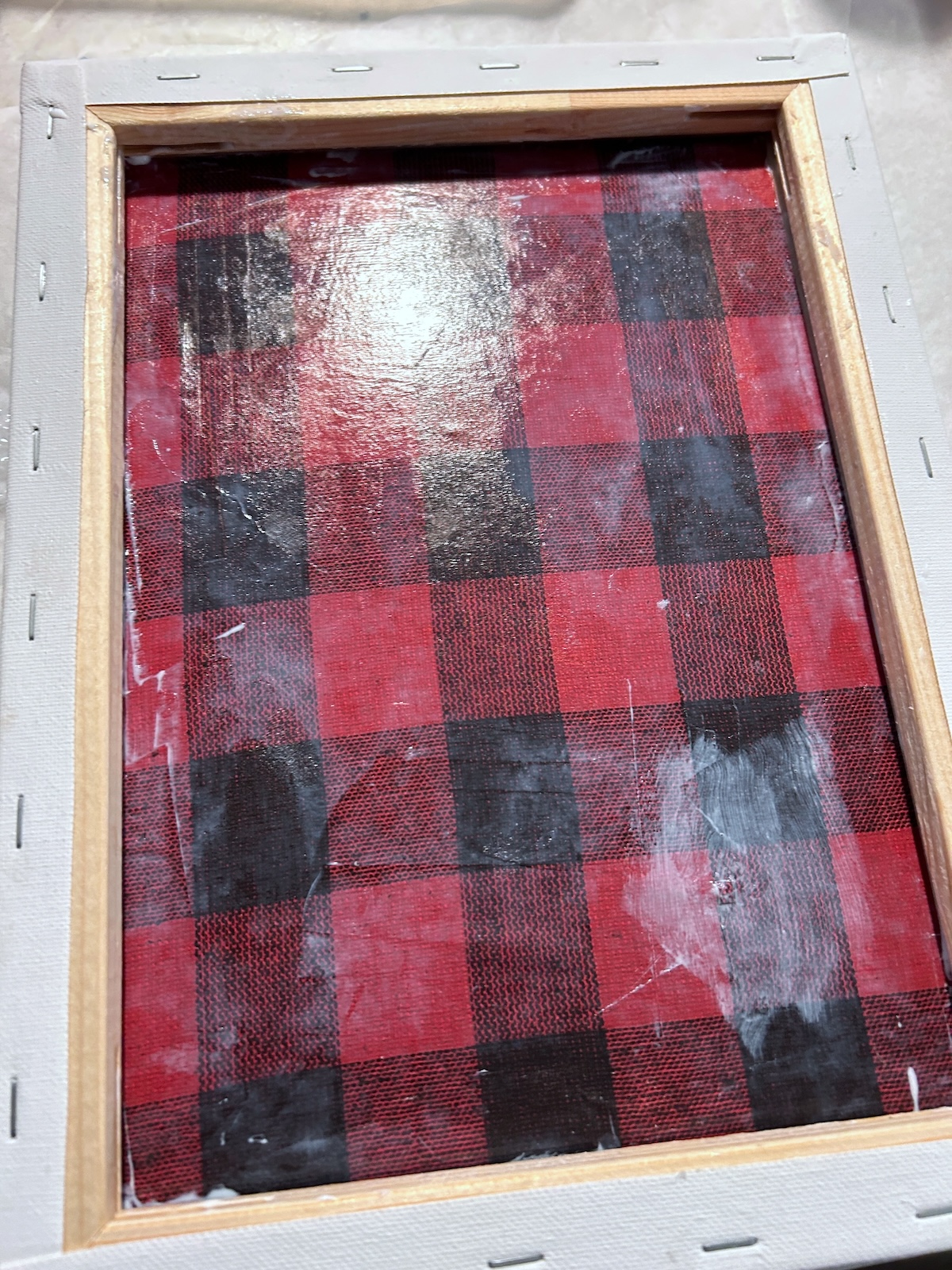 mod podge paper on the inside of the canvas