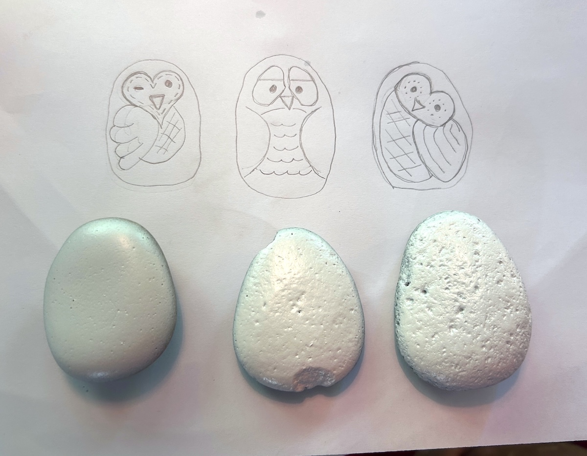 planning owl designs on paper with a pencil
