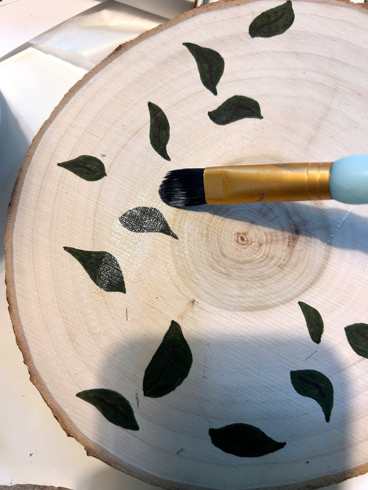 sealing the wood slice with Mod Podge satin