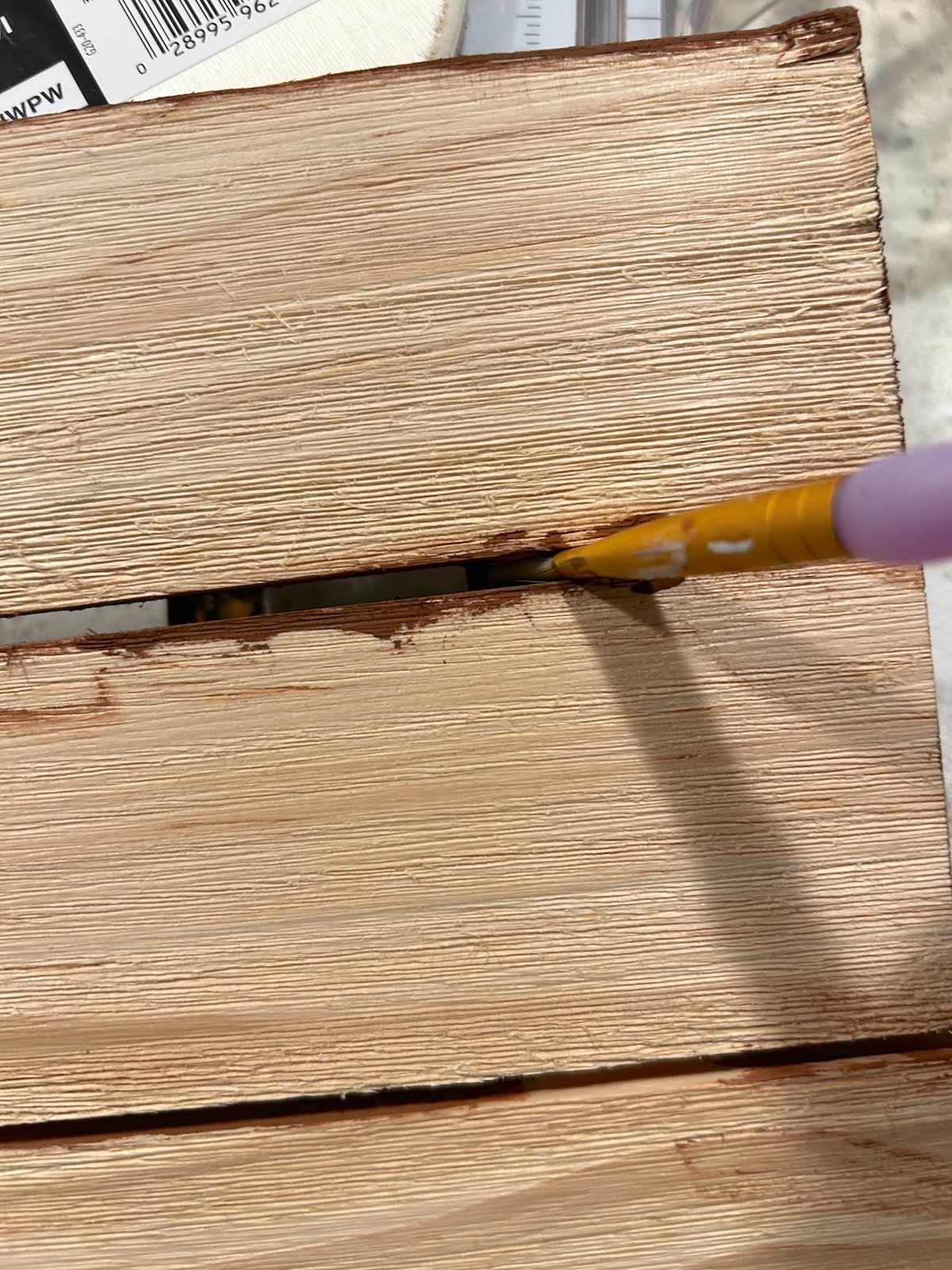 paint in the grooves of the wood pallet