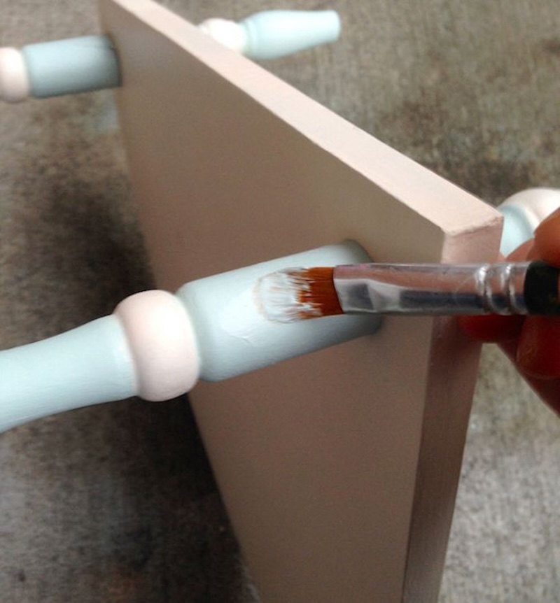 Painting details on the table with a light blue chalk paint